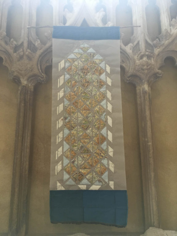 artwork hanging in the chapel of St Marys Priory Church Abergavenny in Wales - part of the St Thomas Way