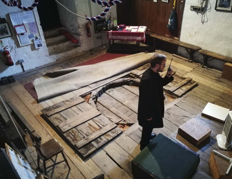 Map of Mundi being installed from the belltower into the nave of St Marys Priory Church Abergavenny in Wales - part of the St Thomas Way