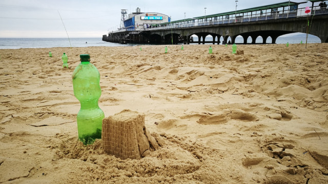 plastic bottle and sandcastle of Plastic Pathways Beach labyrinth on the sand for Arts by the Sea festival by artist Michelle Rumney