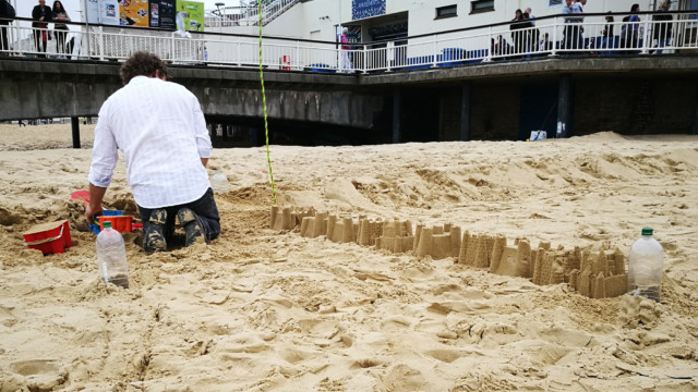 building sandcastles for Plastic Pathways Beach labyrinth on the sand for Arts by the Sea festival by artist Michelle Rumney