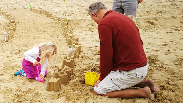 building sandcastles for Plastic Pathways Beach labyrinth on the sand for Arts by the Sea festival by artist Michelle Rumney