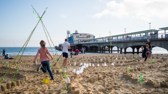 Running through Plastic Pathways Beach labyrinth on the sand for Arts by the Sea festival by artist Michelle Rumney