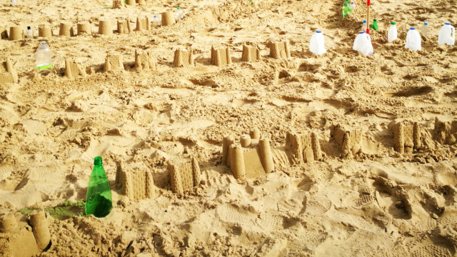 Sandcastles of the Plastic Pathways Beach labyrinth on the sand for Arts by the Sea festival by artist Michelle Rumney