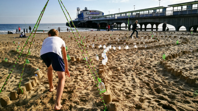 Walking the Plastic Pathways Beach labyrinth on the sand for Arts by the Sea festival by artist Michelle Rumney