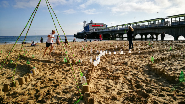 Walking the Plastic Pathways Beach labyrinth on the sand for Arts by the Sea festival by artist Michelle Rumney