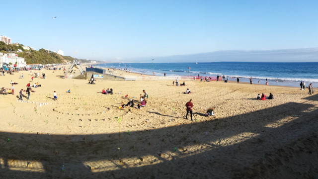 Panorama shot view from pier of Plastic Pathways - beach labyrinth on the sand for Arts by the Sea festival by artist Michelle Rumney