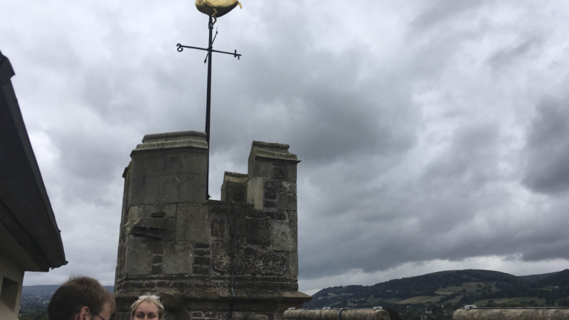 Artist Michelle Rumney with Father Tom on the tower of St Marys Priory overlooking the Black Mountains and Abergavenny